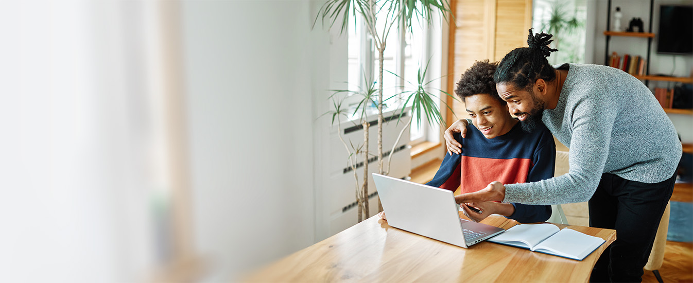 Man and teen looking at a computer