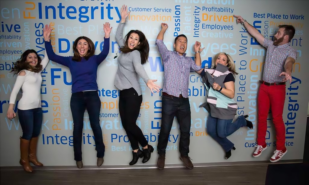 workday employees jumping up by wall