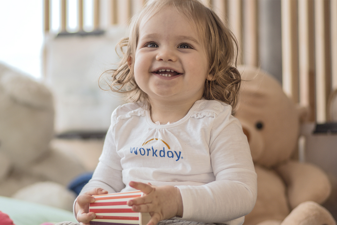 baby in workday onesie smiling